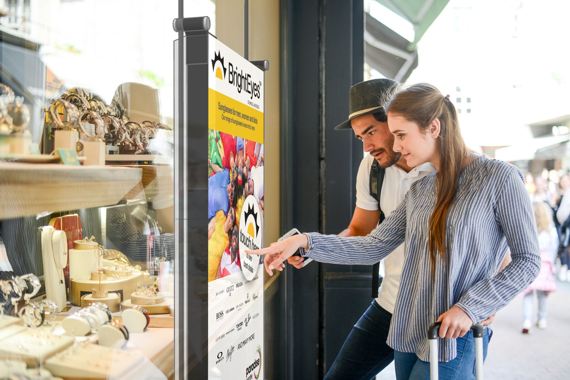 Two people using a digital menu board in a store setting with Brighteyes branding.